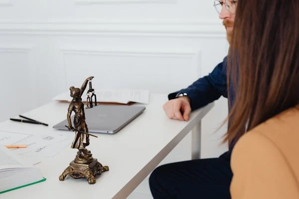 Lady justice statue on lawyer's desk.